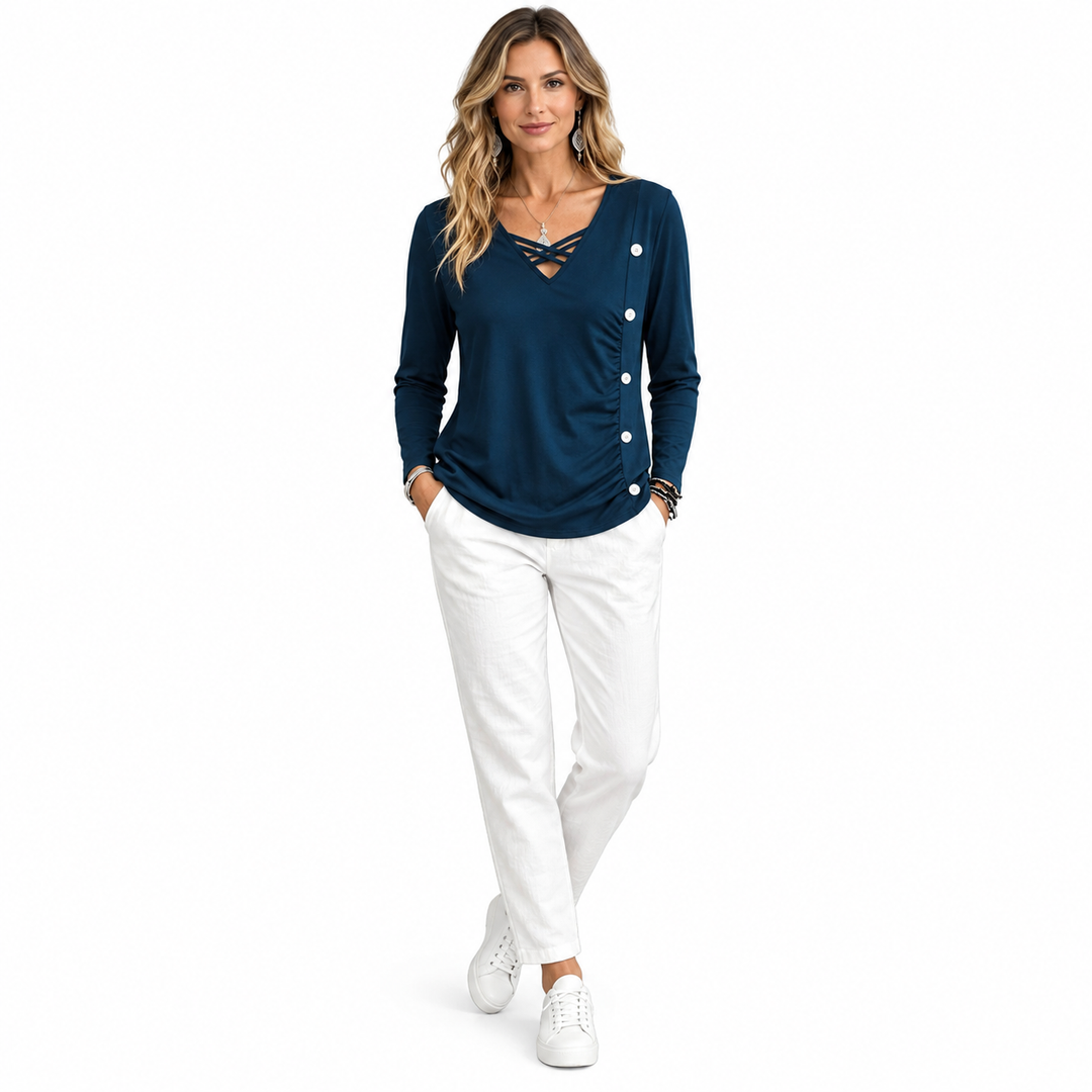 Navy top styled with white trousers and sneakers