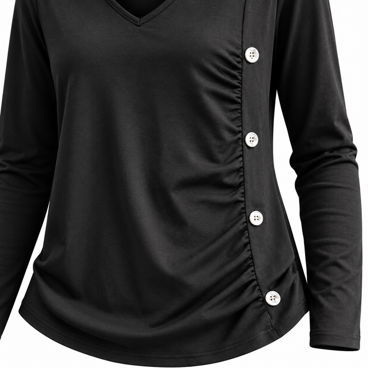 Close-up of decorative buttons and ruching on the dark gray top
