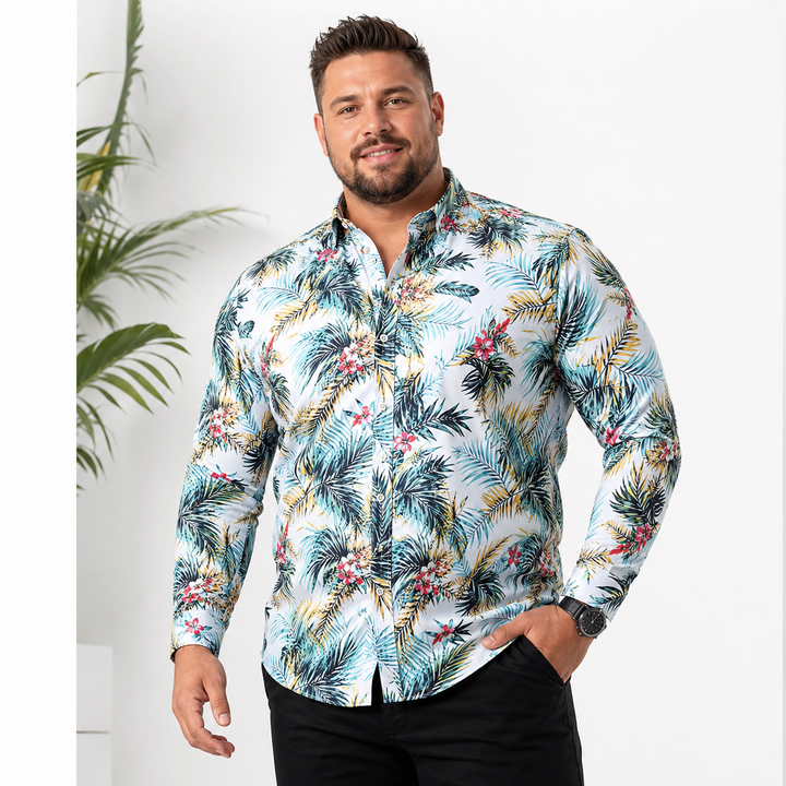 Plus-size male model wearing a light blue tropical print long-sleeve button-up shirt in a bright studio setting.
