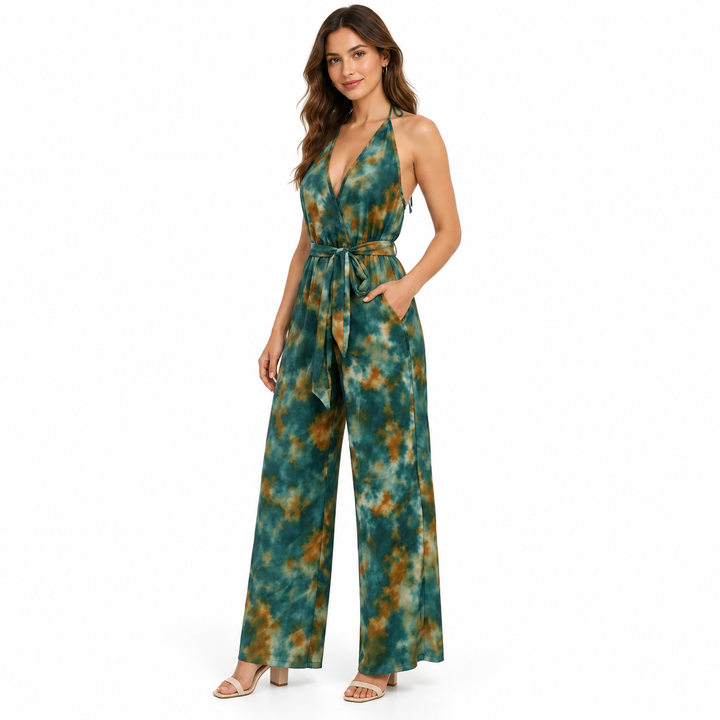Three-quarter view of dark green patterned jumpsuit with a hand in the side pocket