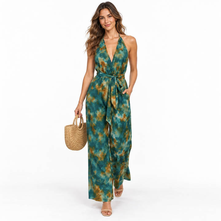 Dark green wide-leg jumpsuit styled with beige sandals and a woven handbag