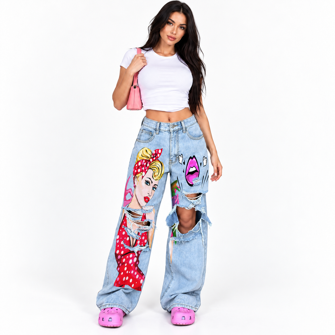 Light blue plus size wide leg jeans with distressed cutouts, colorful art print, front pockets and washed denim finish.