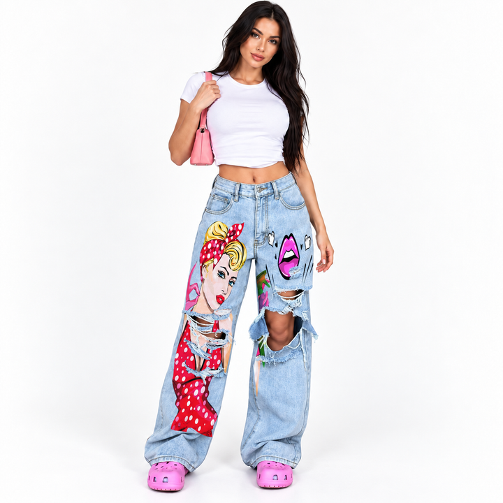 Light blue plus size wide leg jeans with distressed cutouts, colorful art print, front pockets and washed denim finish.