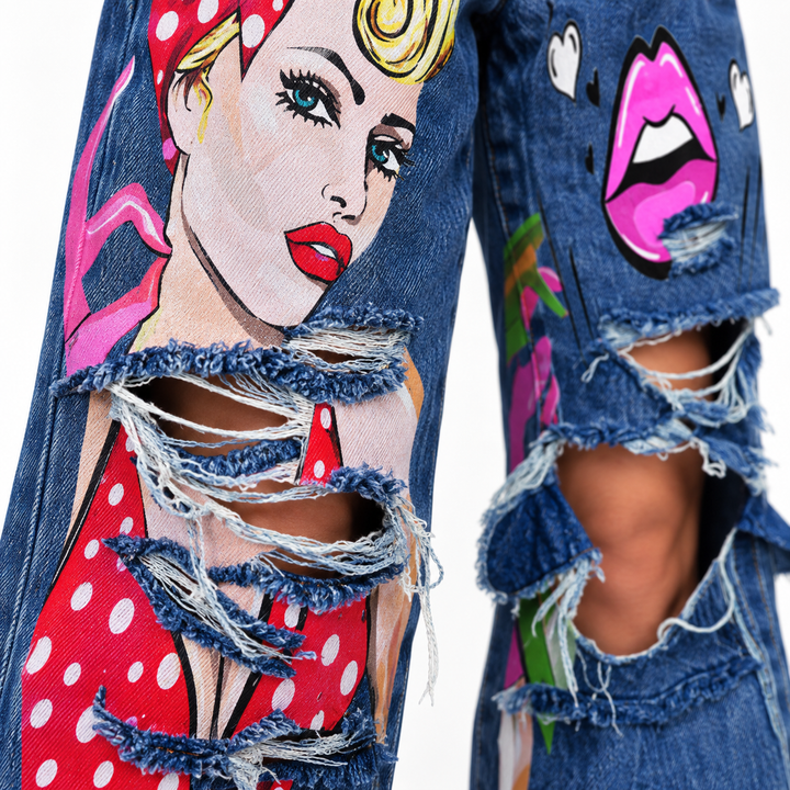 Close-up of black gray jeans showing waistband, belt loops, front pockets, button closure and graphic print details.