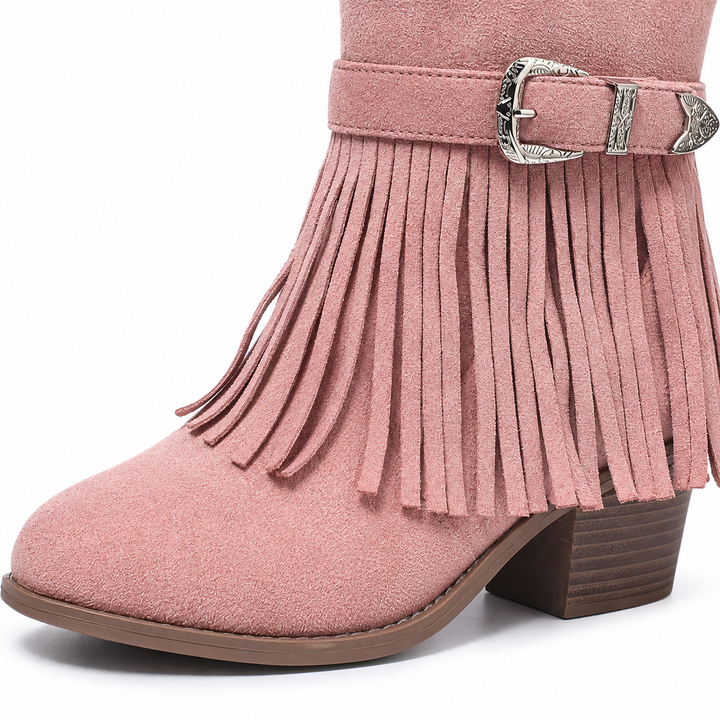 Close view of a pink fringe ankle boot with fringe strips, a rounded toe and silver hardware in a studio photograph on white.