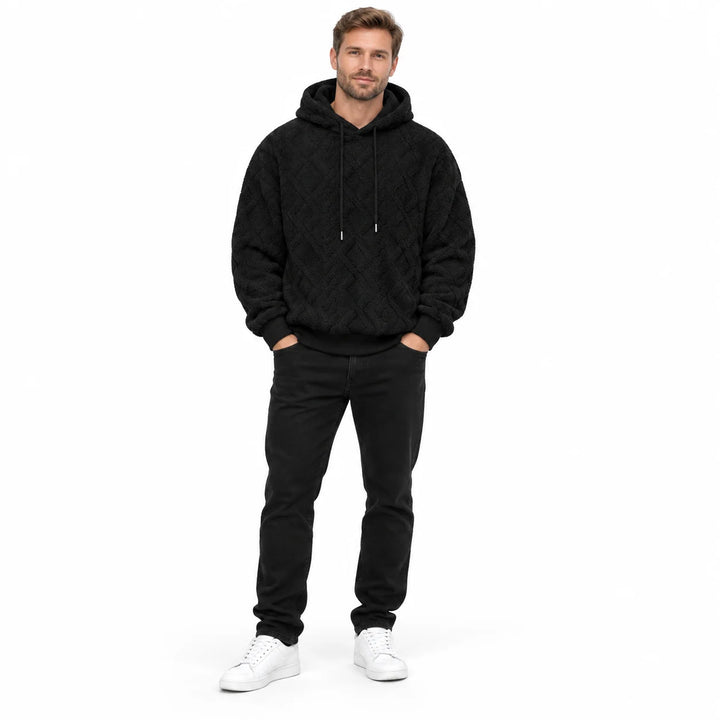 Black jacquard hoodie shown on a second male model from head to toe, with tonal drawstrings, rib cuffs and a diamond pattern.