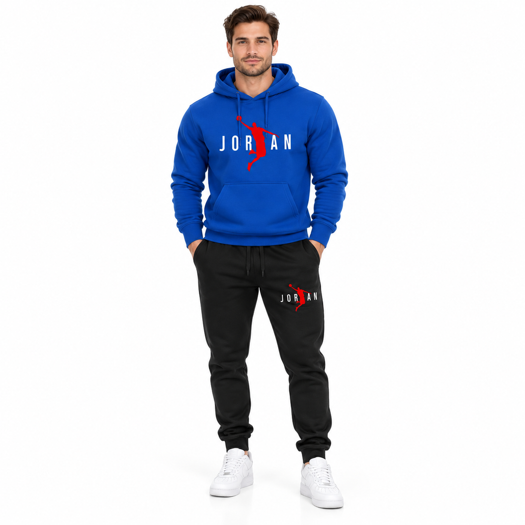 Male model wearing the royal blue / white lettering hoodie and black pants set on a white studio background.