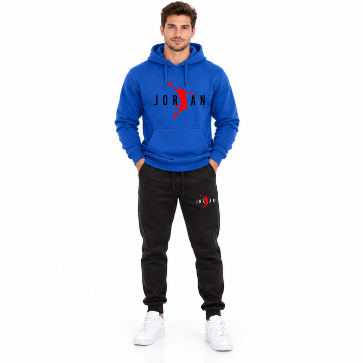 Male model wearing the royal blue / black lettering hoodie and black pants set on a white studio background.