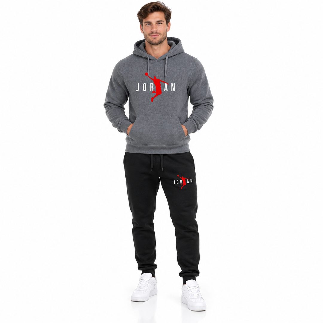 Male model wearing the dark grey / white lettering hoodie and black pants set on a white studio background.