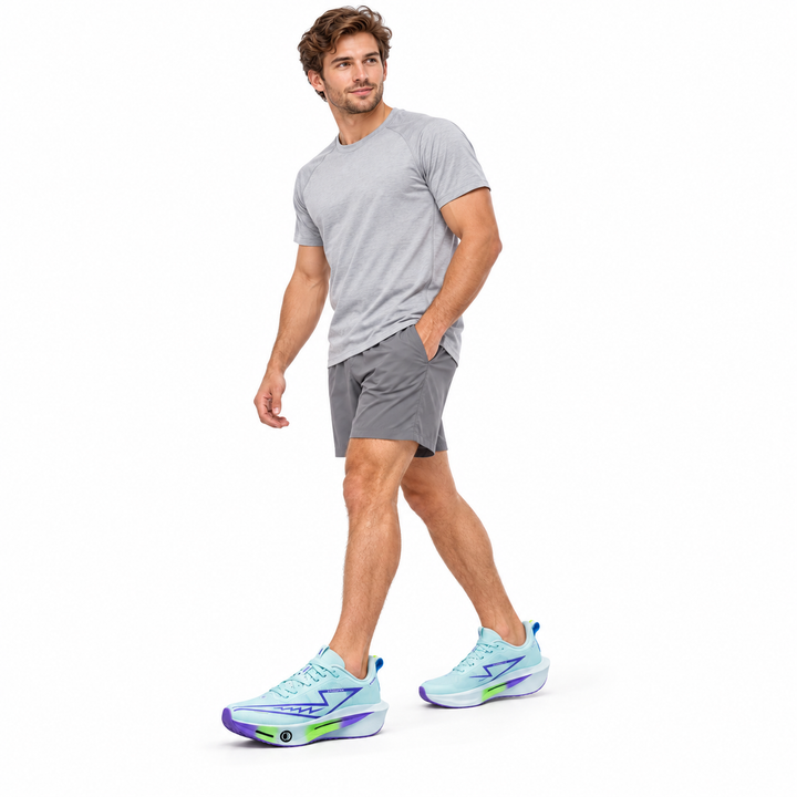 Male model wearing light blue lace-up sneakers on a white studio background.