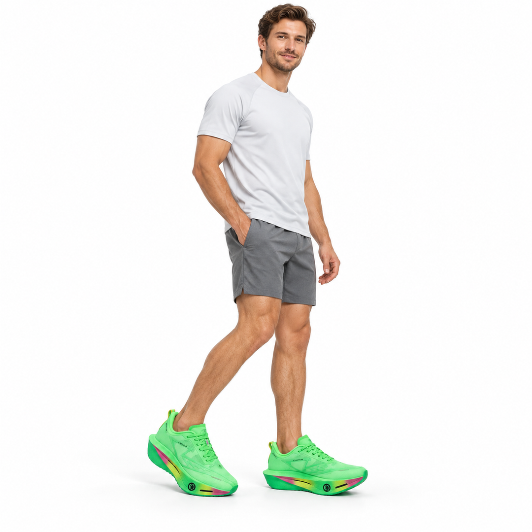 Male model wearing green lace-up sneakers on a white studio background.