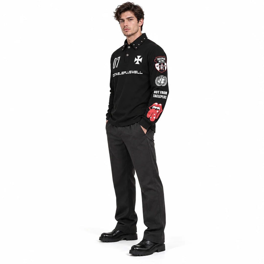 Male model in side view wearing a black printed polo, showing red lips and white sleeve artwork with dark trousers and shoes.