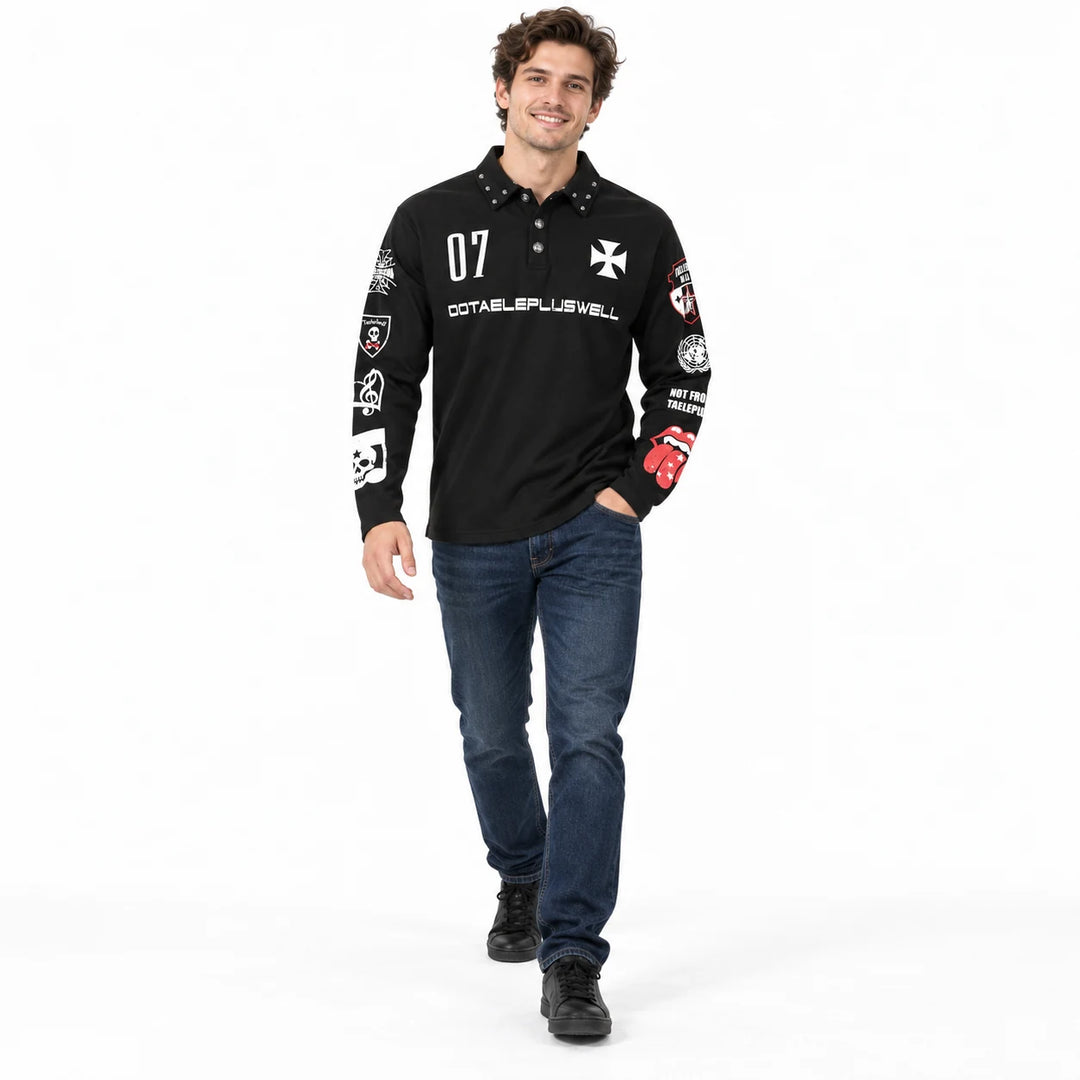 Male model walking in the white studio wearing a black printed long sleeve polo with dark blue jeans and black lace-up shoes.