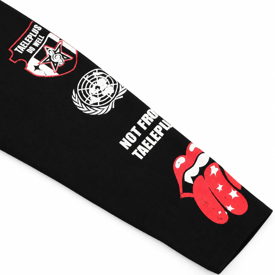 Close-up of the black sleeve showing a red outline badge, white globe, lettering and red lips with white stars near the cuff.