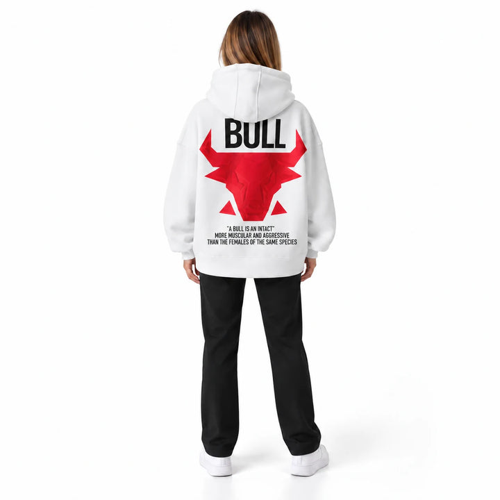 Unisex graphic hoodie in white with a red bull back print, shown on a model wearing black trousers in a white studio setting.