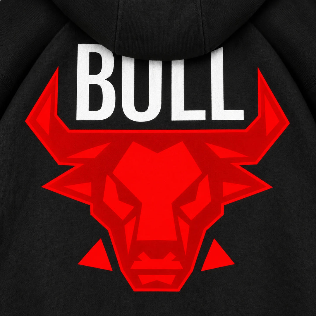 Close view of the red angular bull head and white BULL lettering printed on the back of the black hooded pullover sweatshirt.