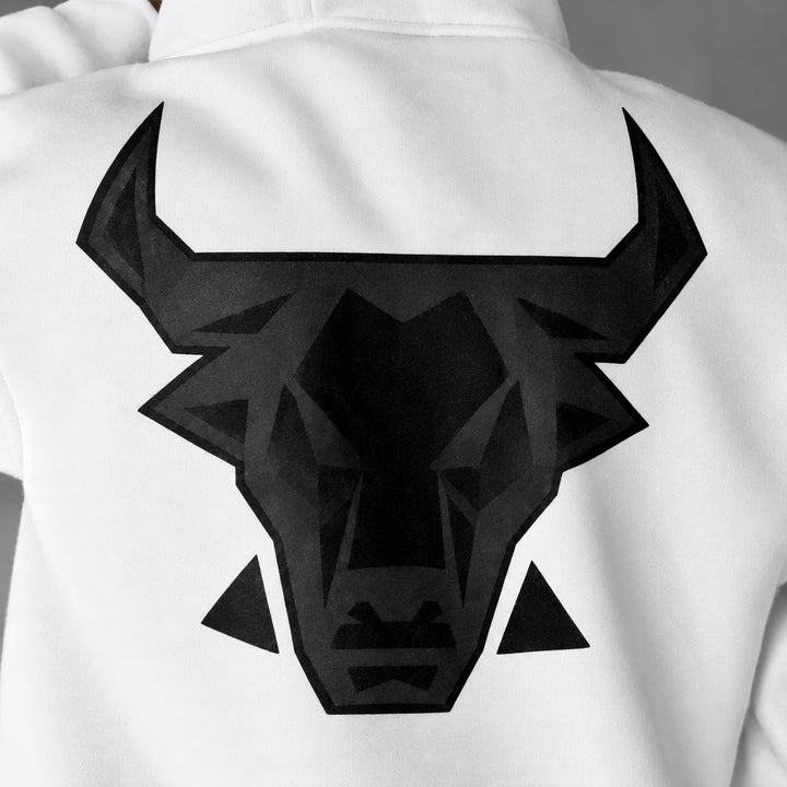 Close detail of the black angular bull head graphic printed on white fabric across the back of the hooded pullover sweatshirt