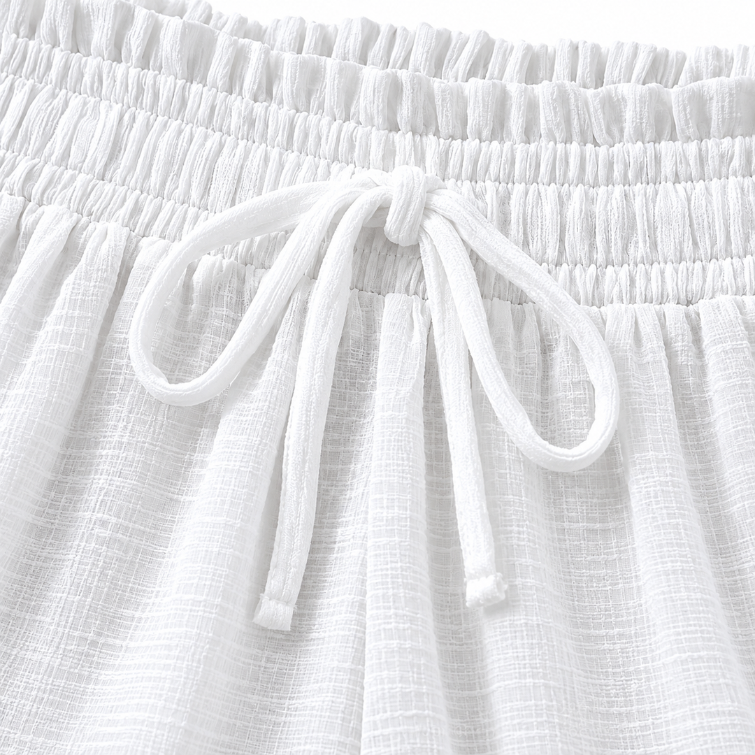 Close-up of the White trousers elastic waistband and tied drawstring