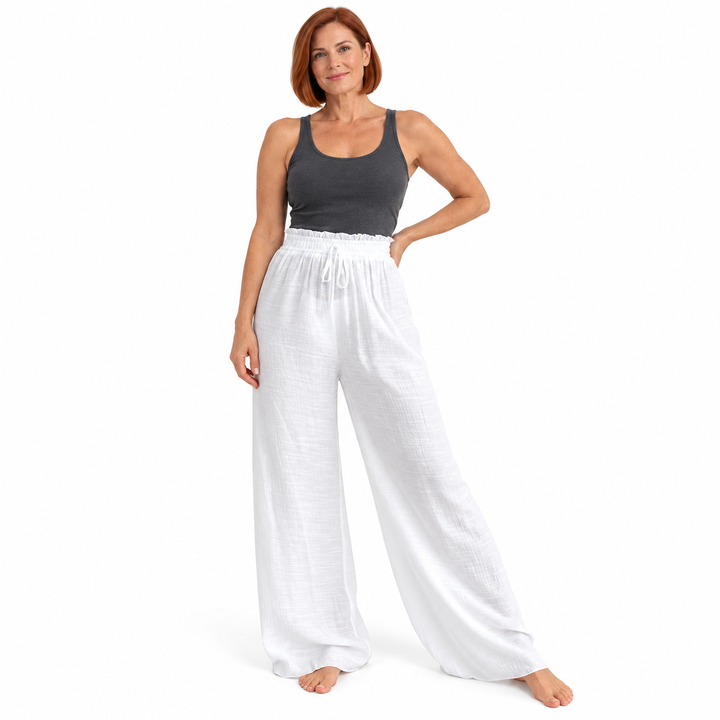 White crinkle trousers worn by a second female model against white