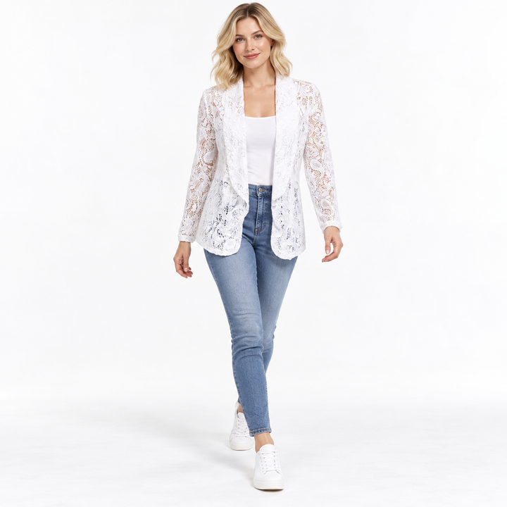 White floral cardigan on a walking model, shown full length on a white background. The floral lace appears for a closer look.