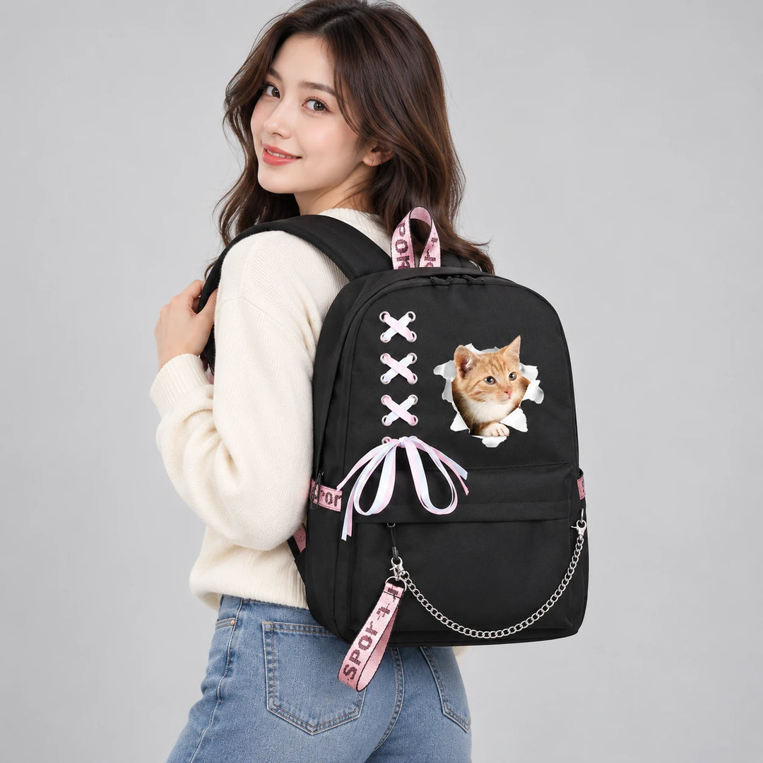 Kawaii cat backpack with orange kitten print worn by an adult model in a cream sweater and jeans, with the whole bag in view.