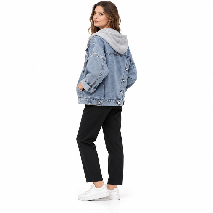 Adult model in side and rear view wearing washed blue denim jacket with grey hood, diagonal back buttons, and cuffed sleeves.