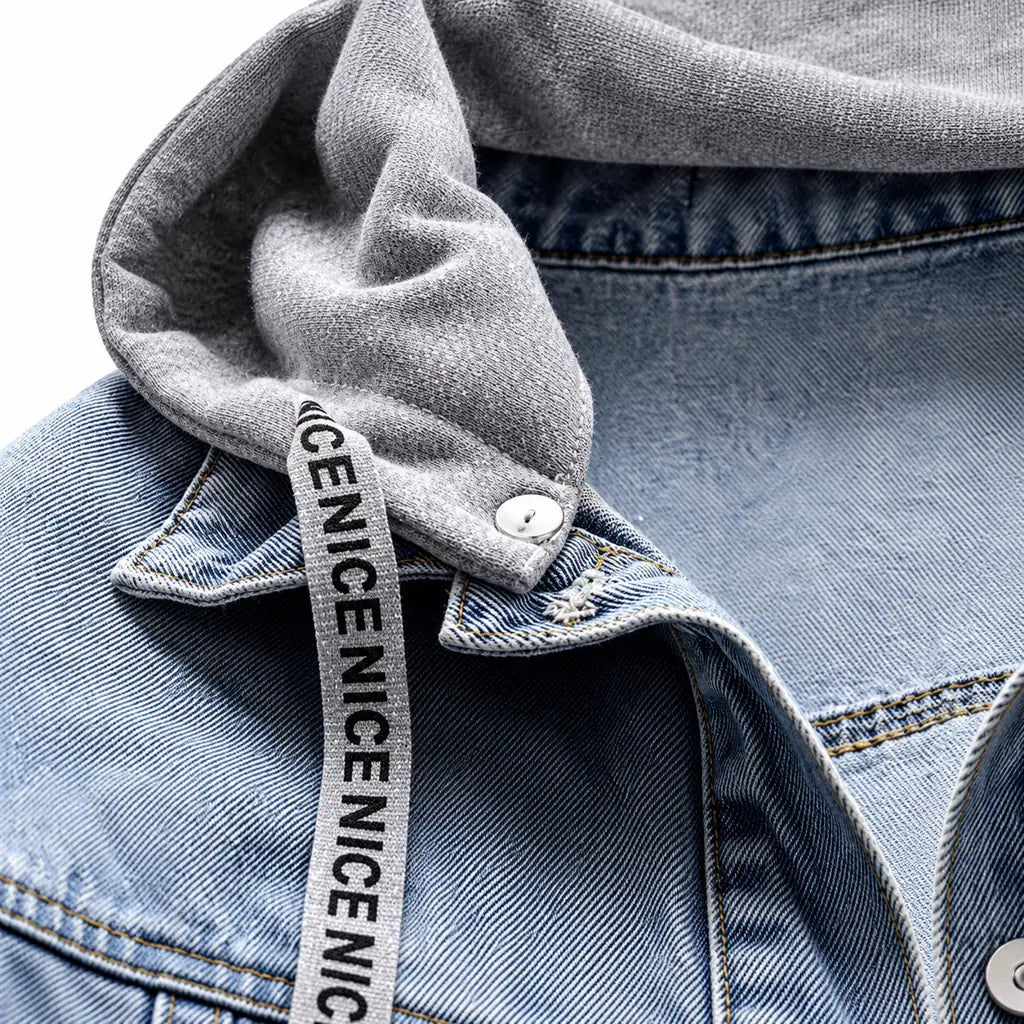 Macro view of the hood attachment, printed NICE drawstring, blue denim collar, metal snap and the original visible stitching.