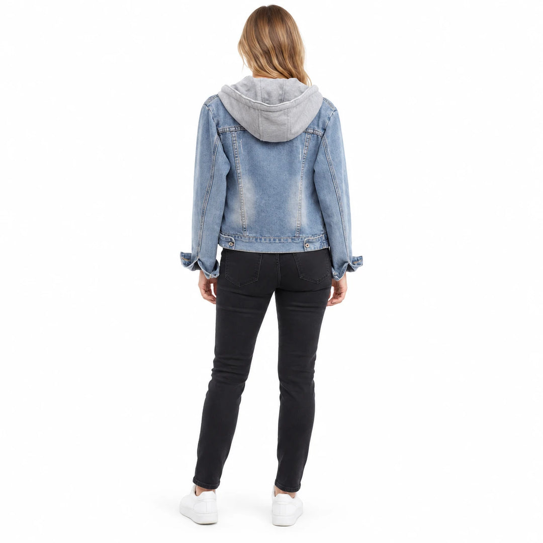 Back view of a light blue denim jacket with a grey hood, seam details and a short hem, worn by a model on a white background.