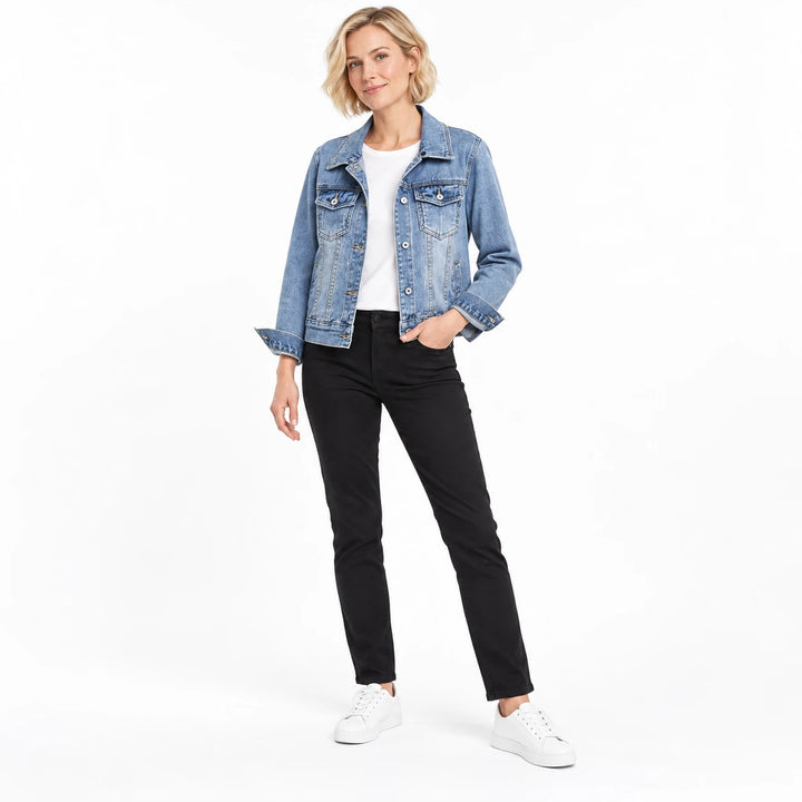 Blonde model wearing a light blue collared denim jacket without a hood, black trousers and white shoes on a white background.
