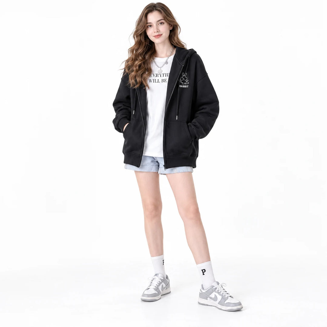 Black rabbit motif zip hoodie worn by an adult woman, showing the hood, zipper and front pockets, against a white background.