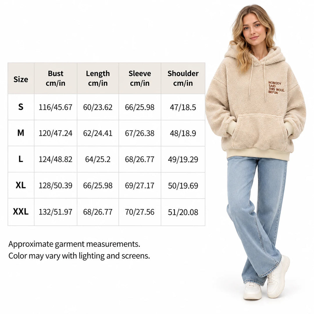 English size guide beside a model, listing bust, length, sleeve and shoulder values for S to XXL, against a white background.