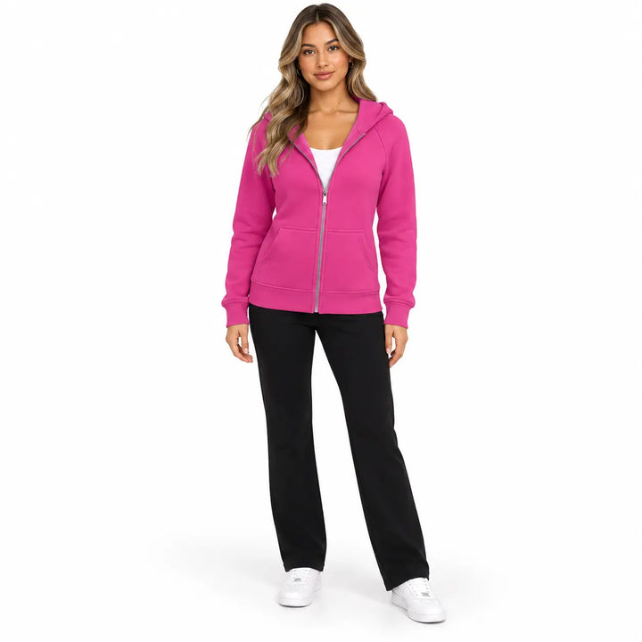 Full-body model wearing the Fuchsia Pink zip hoodie, showing front pockets, ribbed cuffs and hem, with soft shadows on white.