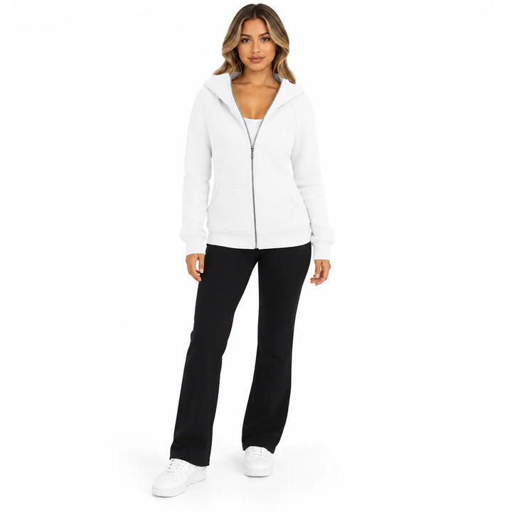 Full-body model wearing the White zip hoodie, showing front pockets, ribbed cuffs and hem, against a white studio background.