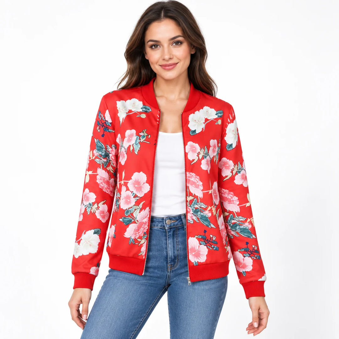 Model wearing the Red printed jacket over a white top and blue jeans, showing pale flowers, long sleeves and red ribbed trim.