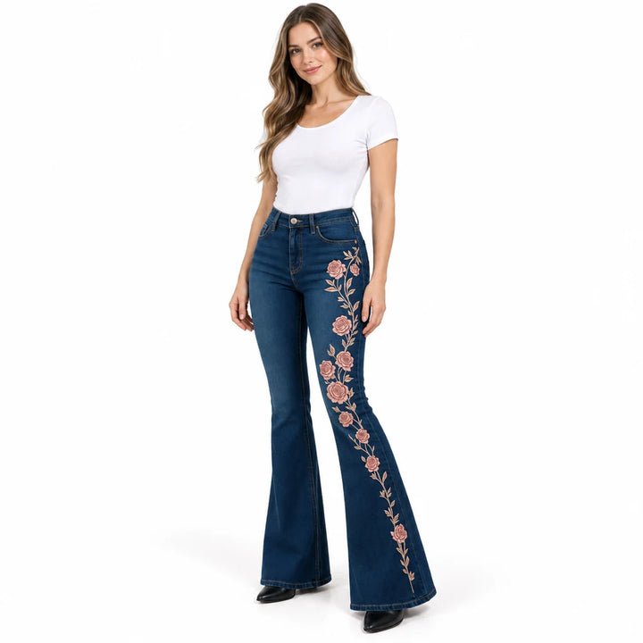 Model wearing dark blue slim-fit flare jeans with a dusty rose floral print down one leg, shown against a white background.