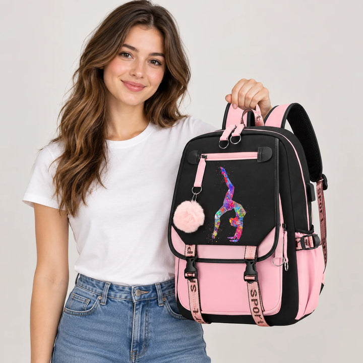 Adult model holding a pink and black gymnastics backpack with the watercolor handstand print, pink pendant and buckle straps.