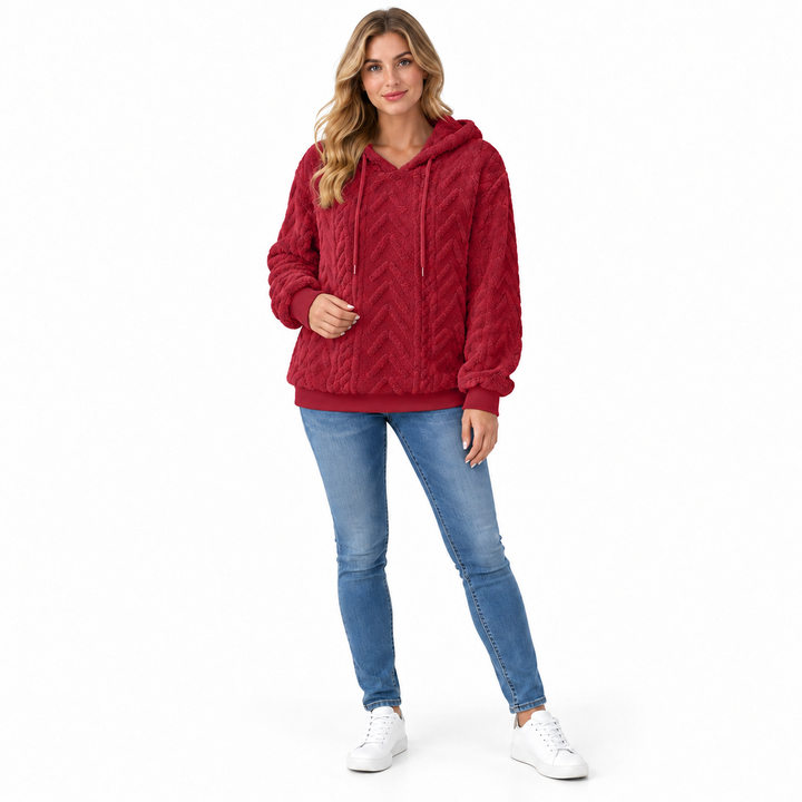 Red textured hoodie on a model, shown in a front pose on a white background. This textured fabric is shown for a closer look.