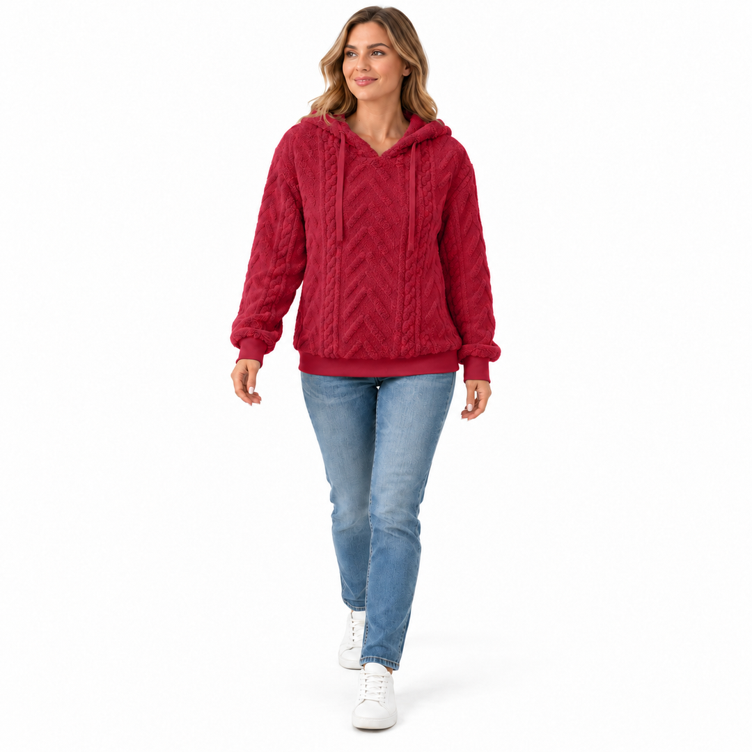 Red textured hoodie on a walking model, shown full length on a white background. The textured fabric is visible in this view.