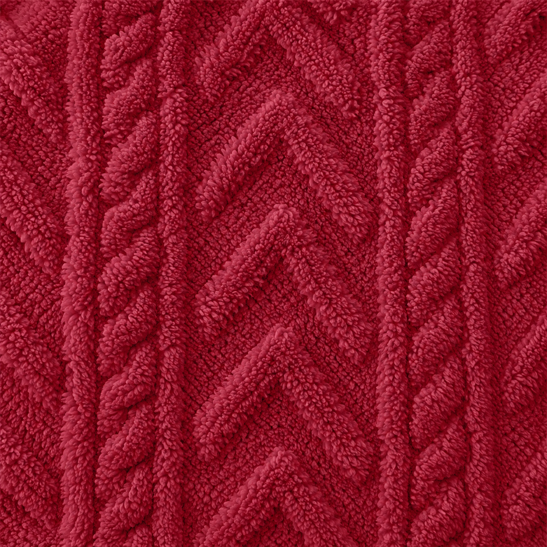 Close view of the red hoodie fabric with raised cable and chevron texture. The textured fabric can be seen for a closer look.