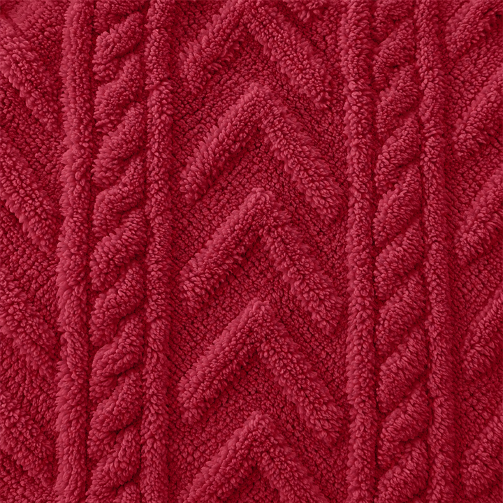 Close view of the red hoodie fabric with raised cable and chevron texture. The textured fabric can be seen for a closer look.