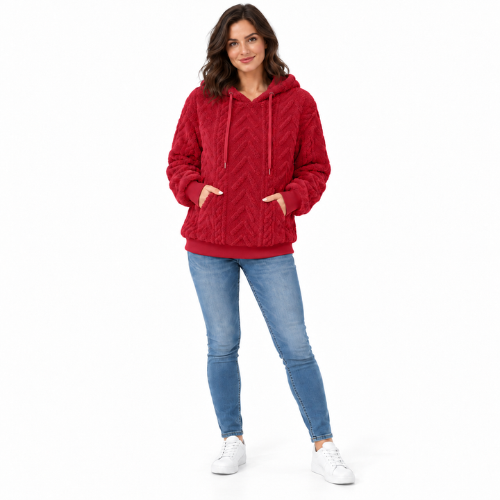 Red hoodie on a brunette model, shown full length on a white background. The textured fabric appears in the pictured garment.