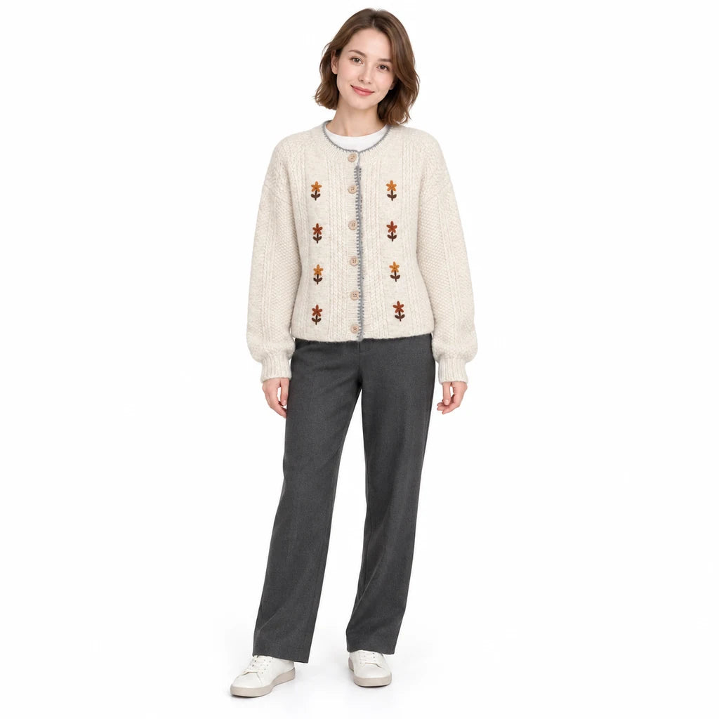 Embroidered cardigan in ivory on a full-length model, showing the round neck, floral embroidery and button closure in studio.