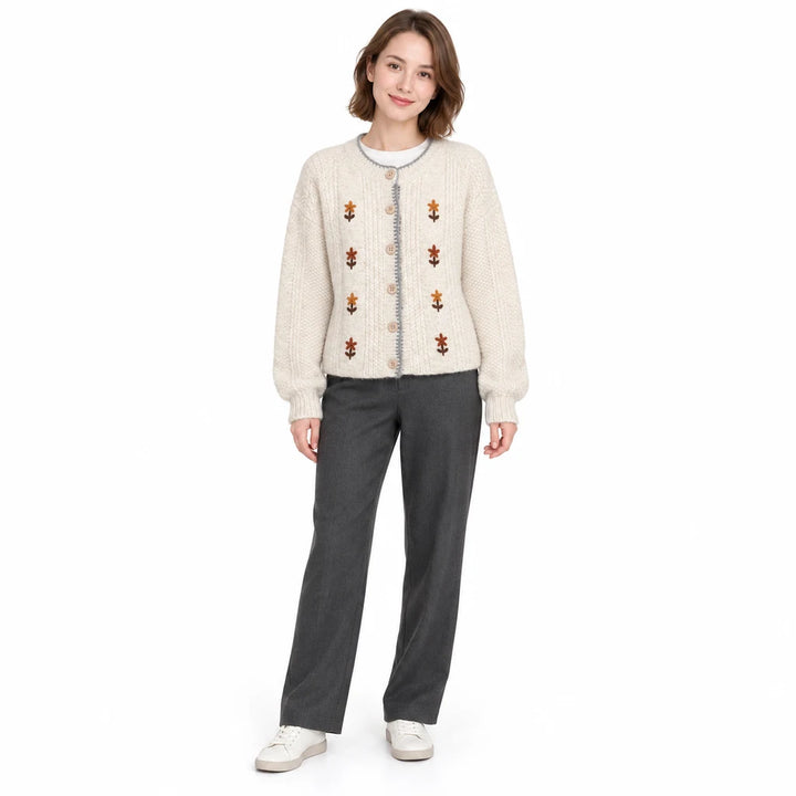 Embroidered cardigan in ivory on a full-length model, showing the round neck, floral embroidery and button closure in studio.