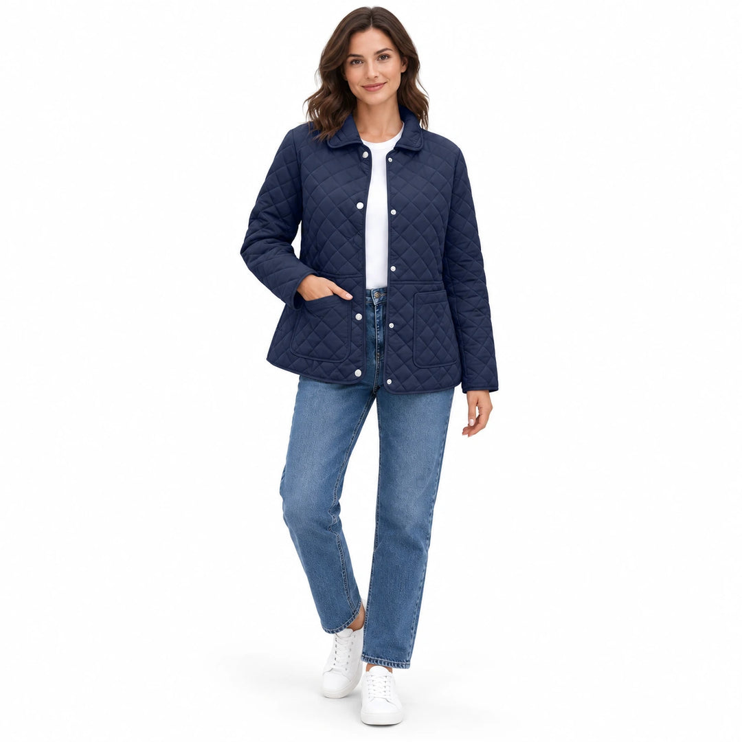 Navy Blue quilted jacket on a full-body model with blue jeans and white sneakers, in a casual pose in a white studio setting.