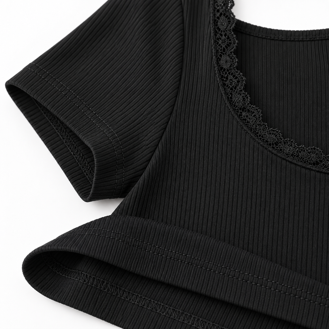 Black ribbed fabric, sleeve seam, hem stitching and lace trim close-up