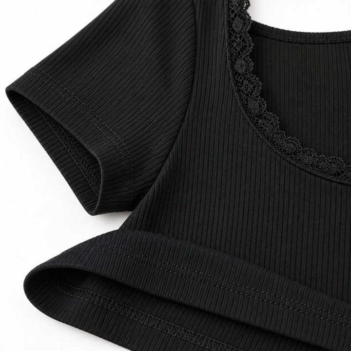 Black ribbed fabric, sleeve seam, hem stitching and lace trim close-up