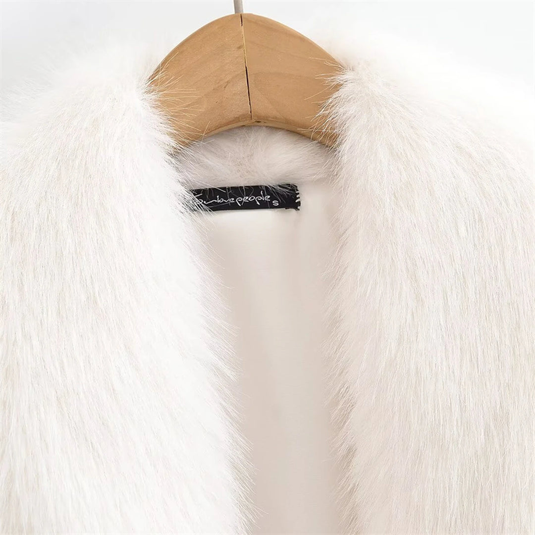 Inside neckline detail of the white jacket on a wooden hanger, showing the sewn-in label, inner fabric and wide fuzzy collar.