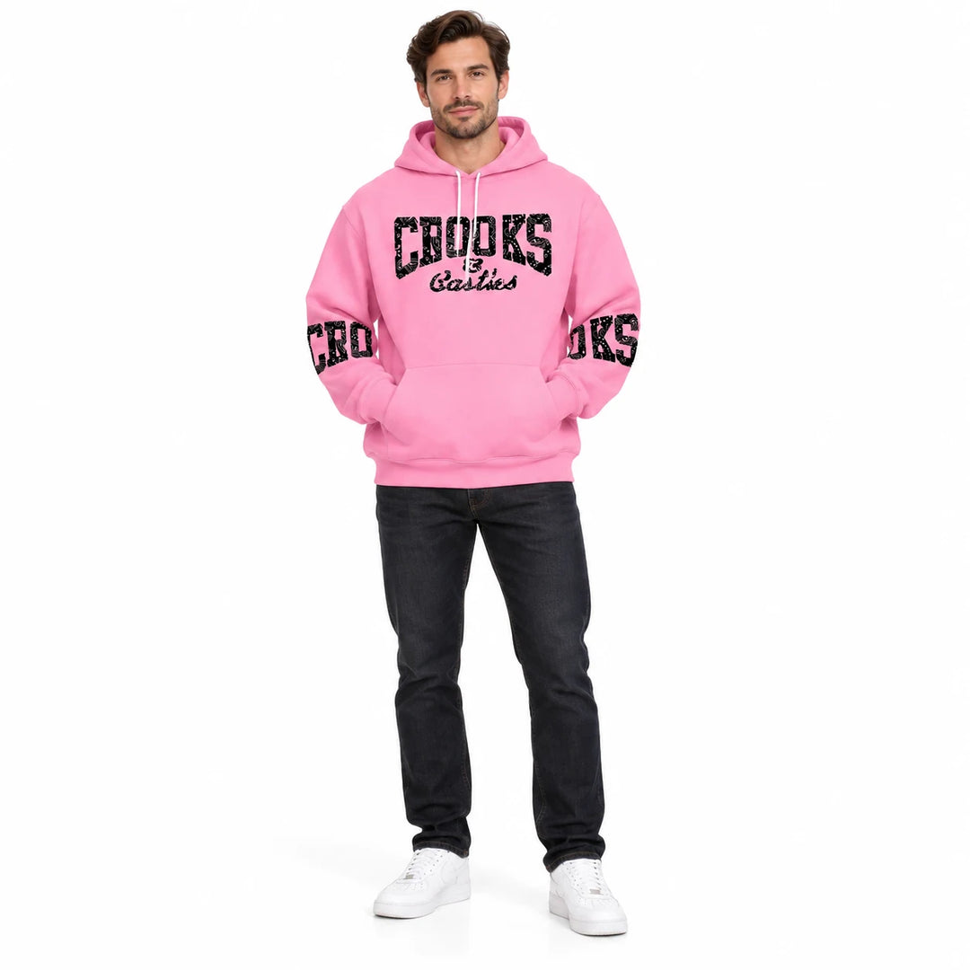Full-length male model wearing a Pink graphic hoodie with chest and sleeve prints on a white studio background