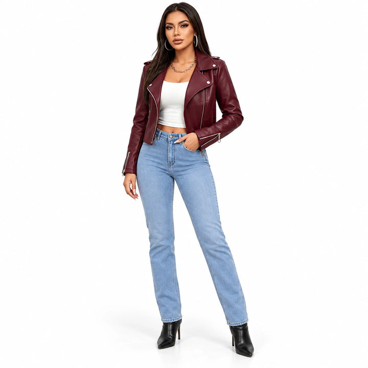 Burgundy slim-fit moto jacket on a full-body model with blue jeans, showing lapel snaps, zip cuffs and a short waistline hem.