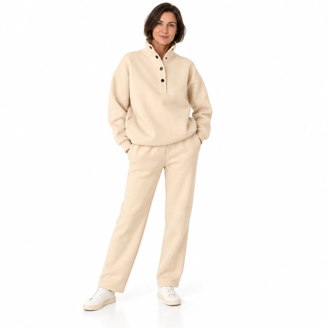 Beige matching set with a stand collar and dark buttons, worn by an adult model in a front view on a white studio background.